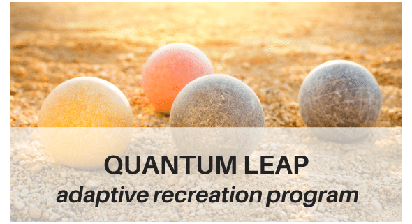 Photo of 4 bocce balls in sand up close w/QL name