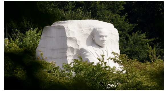 Photo: MLK memorial among green pine & leaves