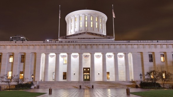 Canva Photo of the Ohio Statehouse at night, lit-up.