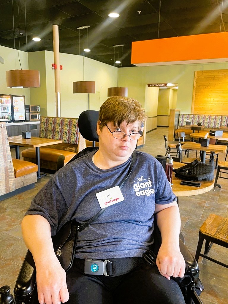 Woman in a Giant Eagle shirt and name tag. 