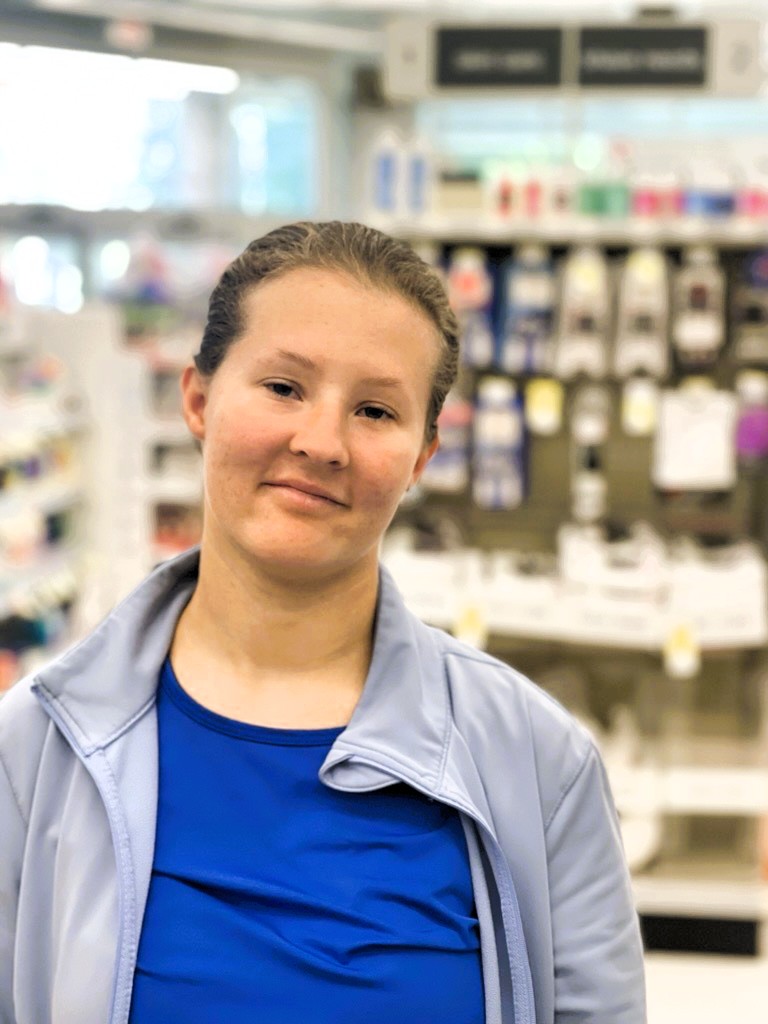 A girl smiles in Walgreens. 